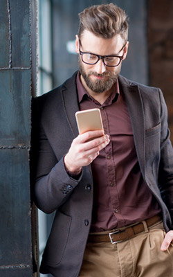 Man wearing glasses using his smartphone